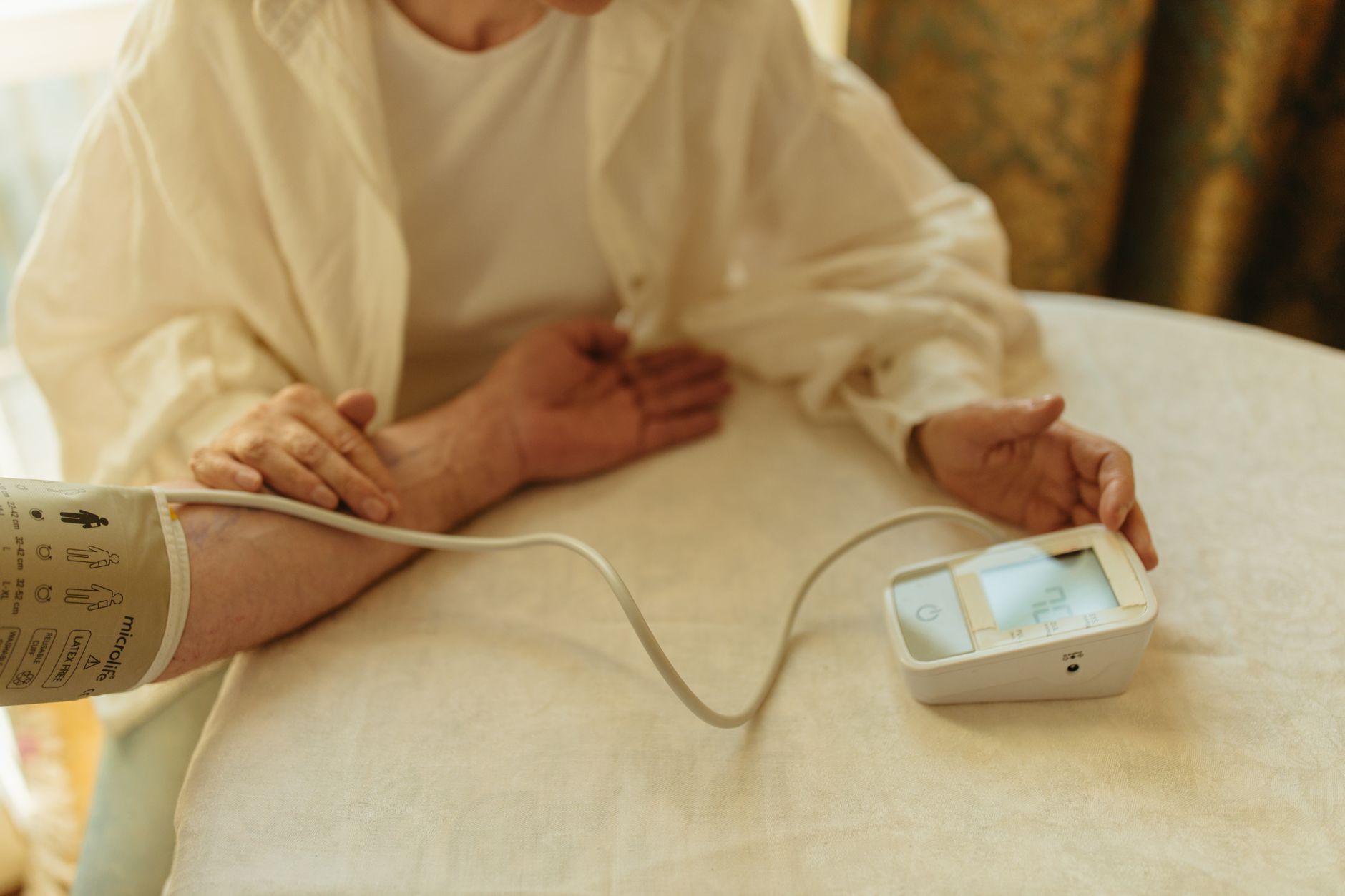 Patient checking blood pressure at home as part of routine health tracking
